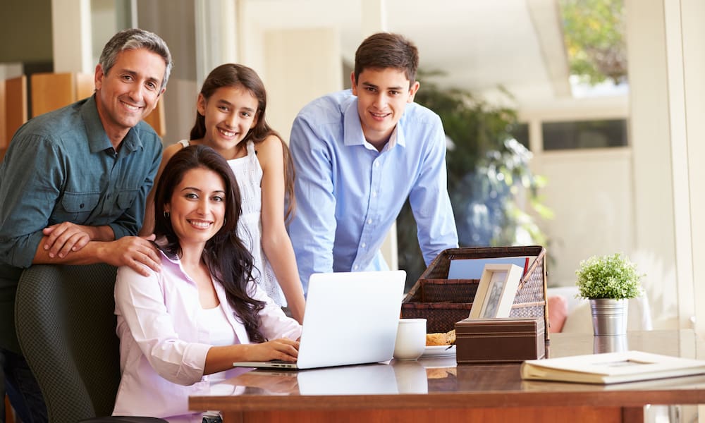 Portrait,Of,Family,Using,Laptop,Together